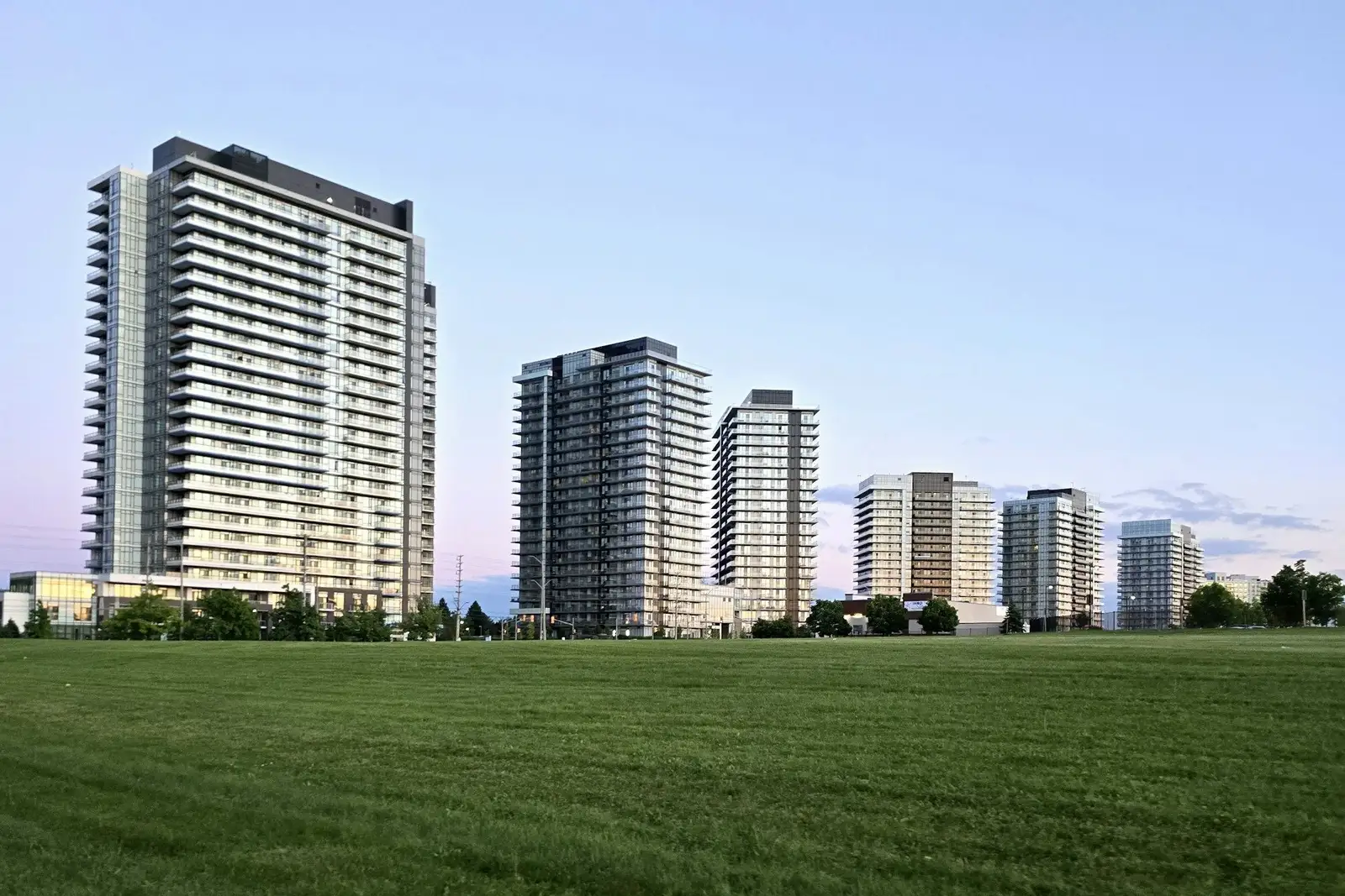 Row of residential towers beyond a wide lawn