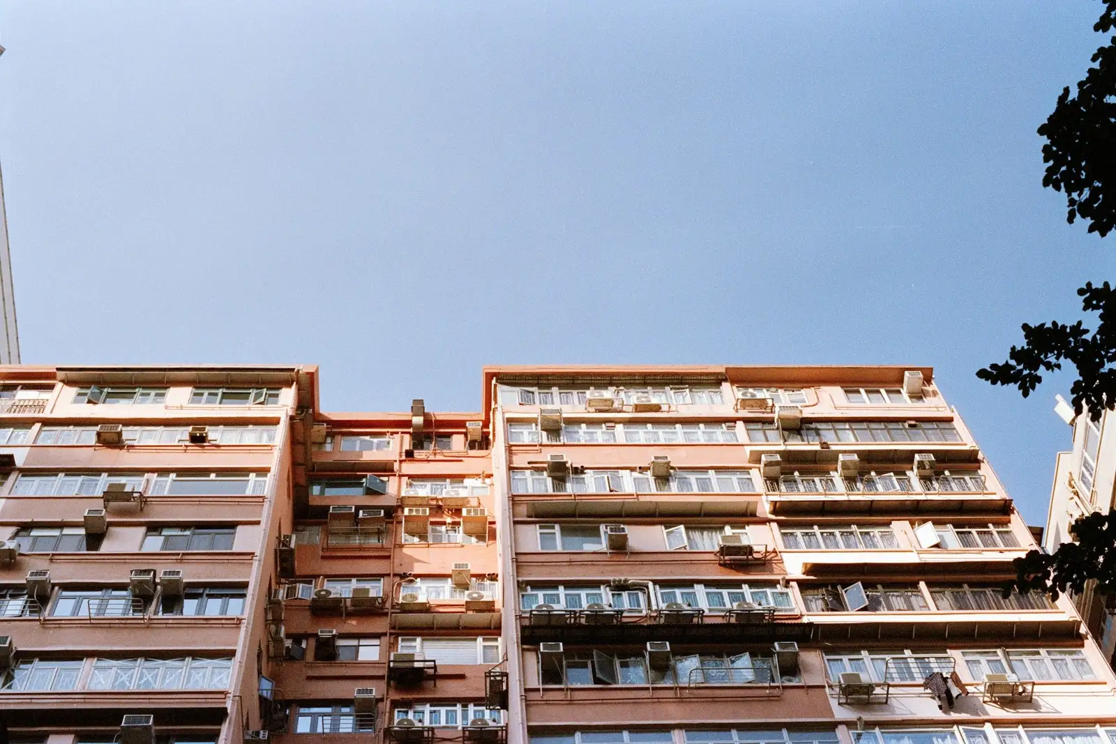 Older apartment towers with window air-conditioners, seen from below