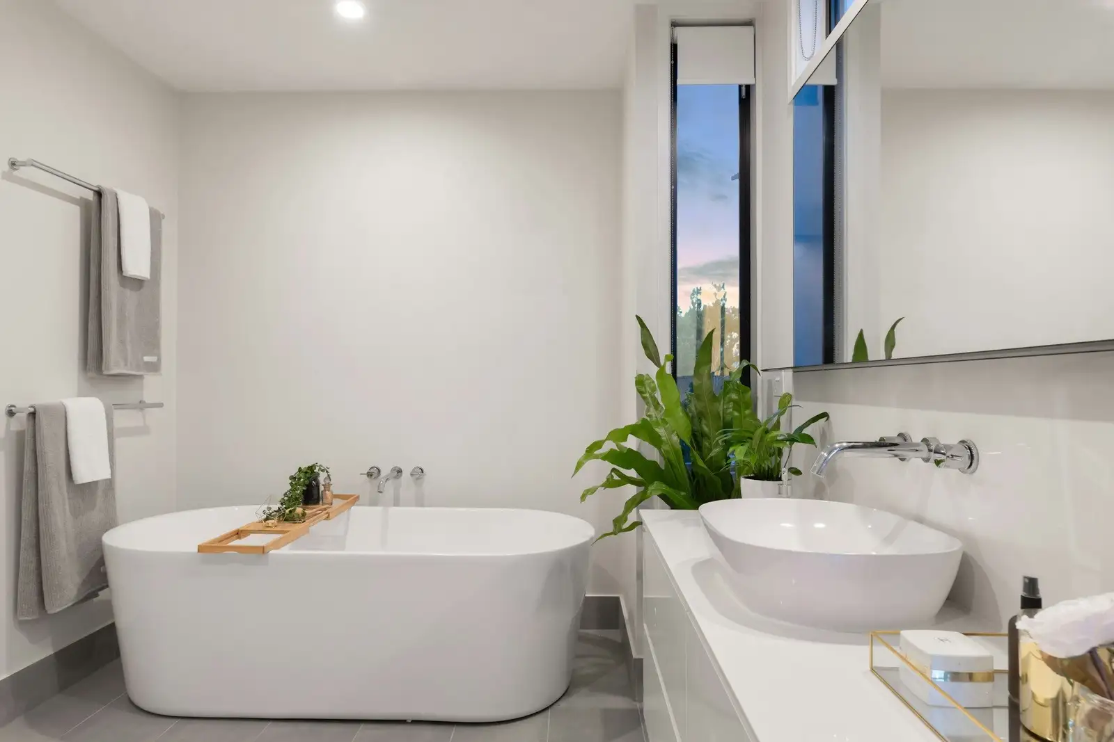 White bathroom with a freestanding tub and a vessel sink