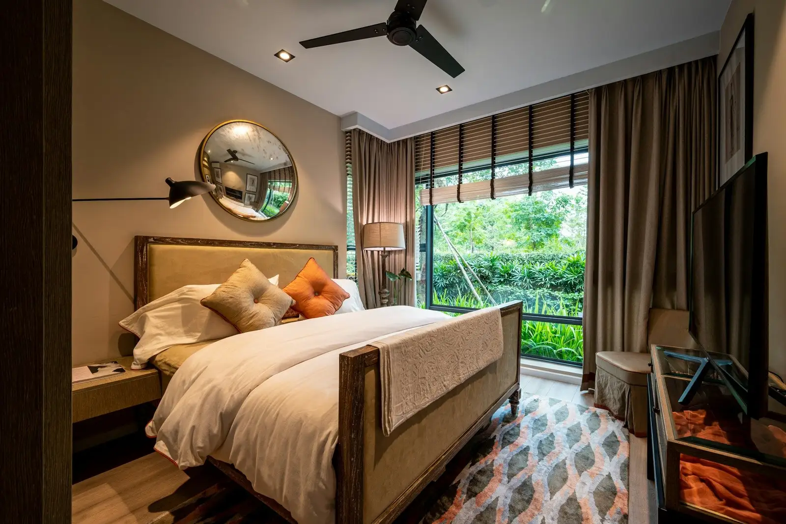 Bedroom with an upholstered bed, a ceiling fan and a glass wall