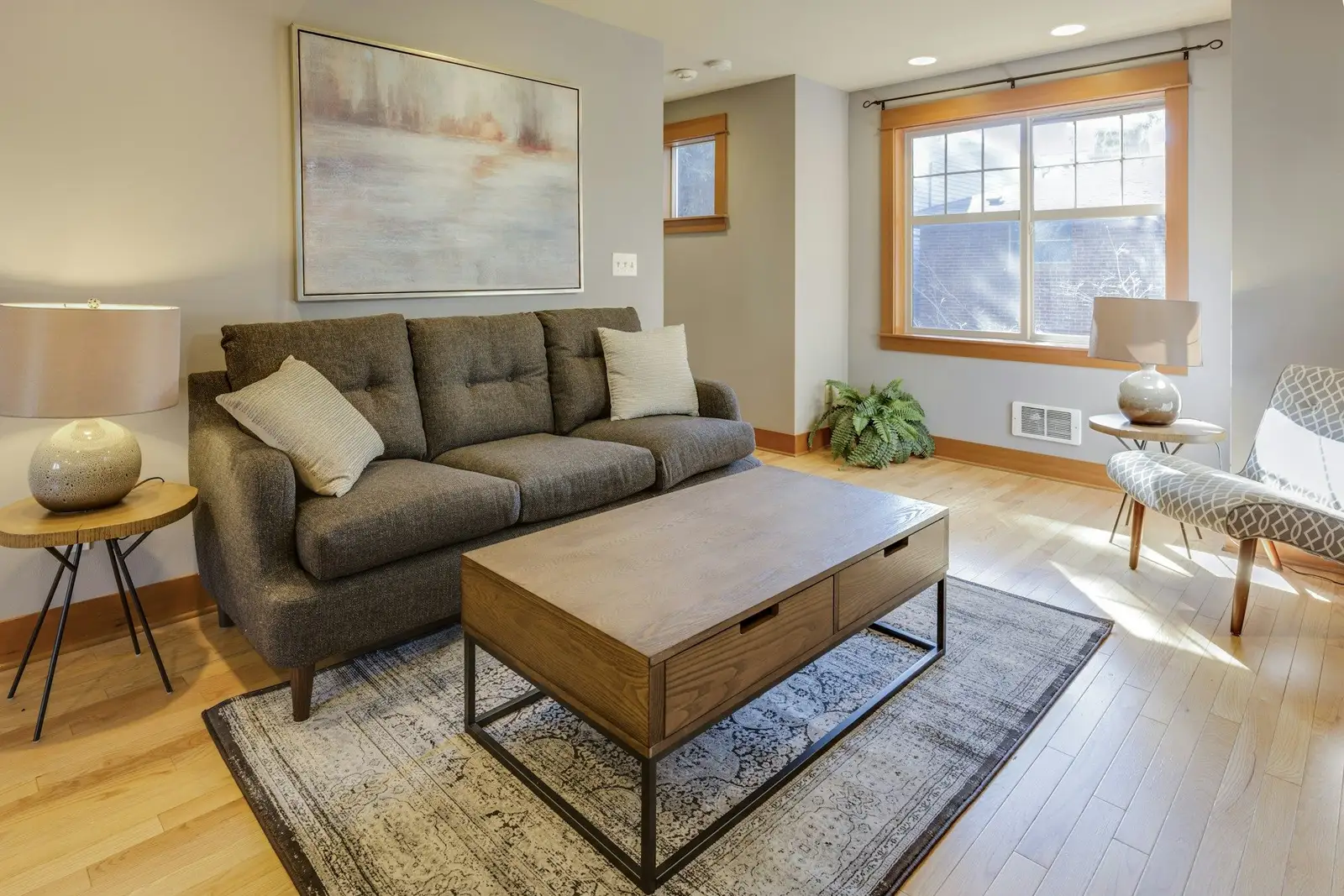 Living room with a grey sofa and a wooden coffee table
